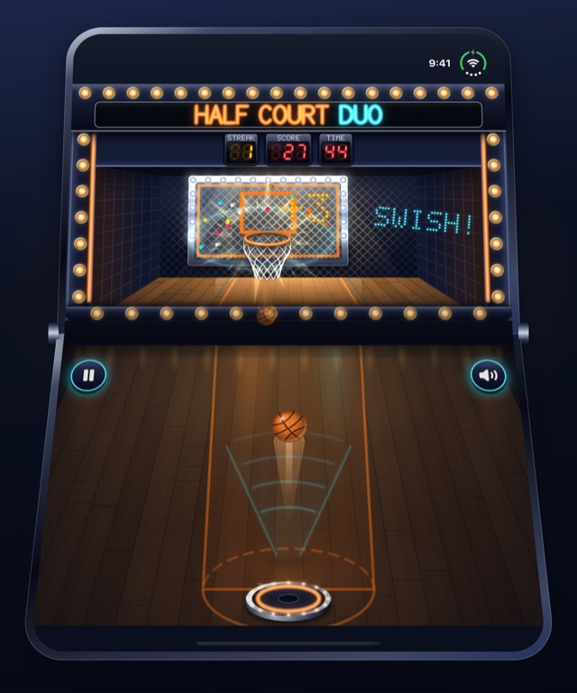 A clean swish: the ball dropping out of the net, SWISH lit beside the backboard, and the next ball on its way up from the pad.
